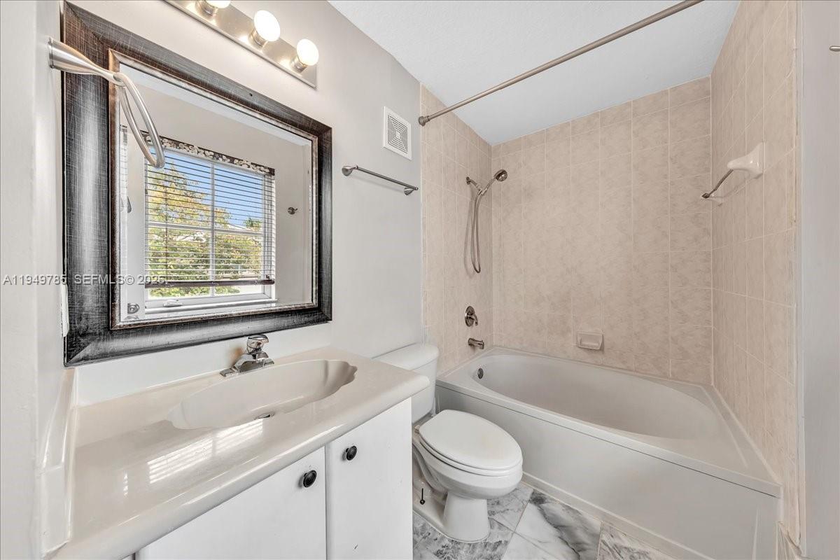 4341 Southwest 160th Avenue, Unit 201 Miramar, FL 33027 - Photo 41 of 53 a bathroom with a bathtub shower sink vanity mirror and toilet