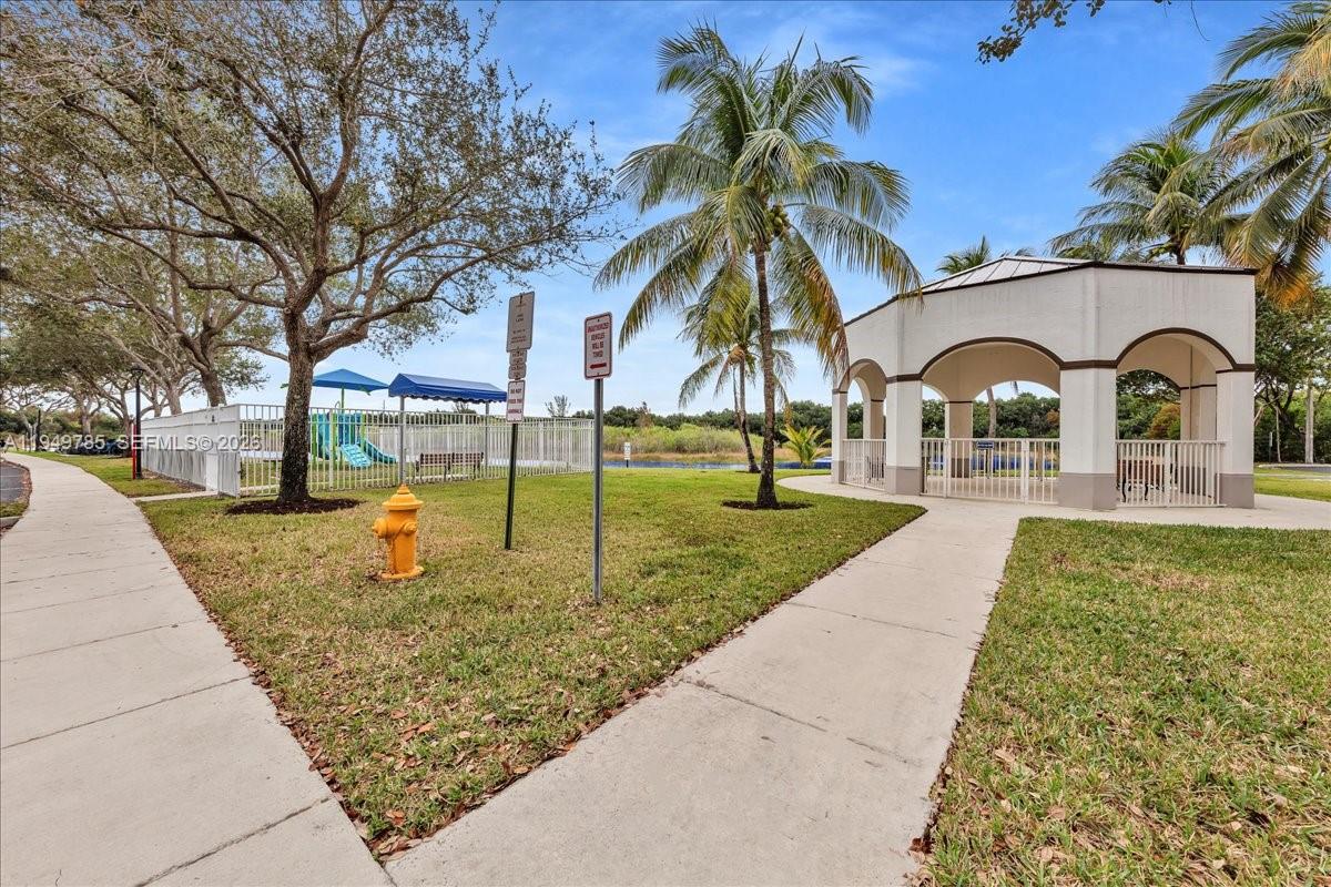 4341 Southwest 160th Avenue, Unit 201 Miramar, FL 33027 - Photo 45 of 53 a front view of a house with garden
