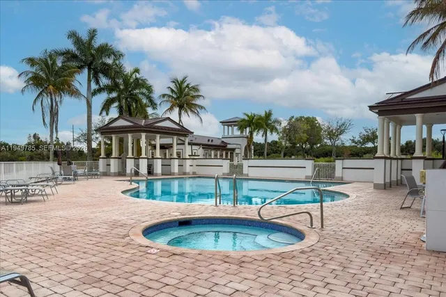 a view of swimming pool with sitting area
