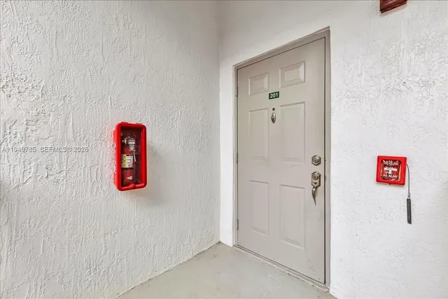 a view of a tall building with a big yard and palm trees
