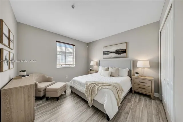 a bedroom with a bed and wooden floor