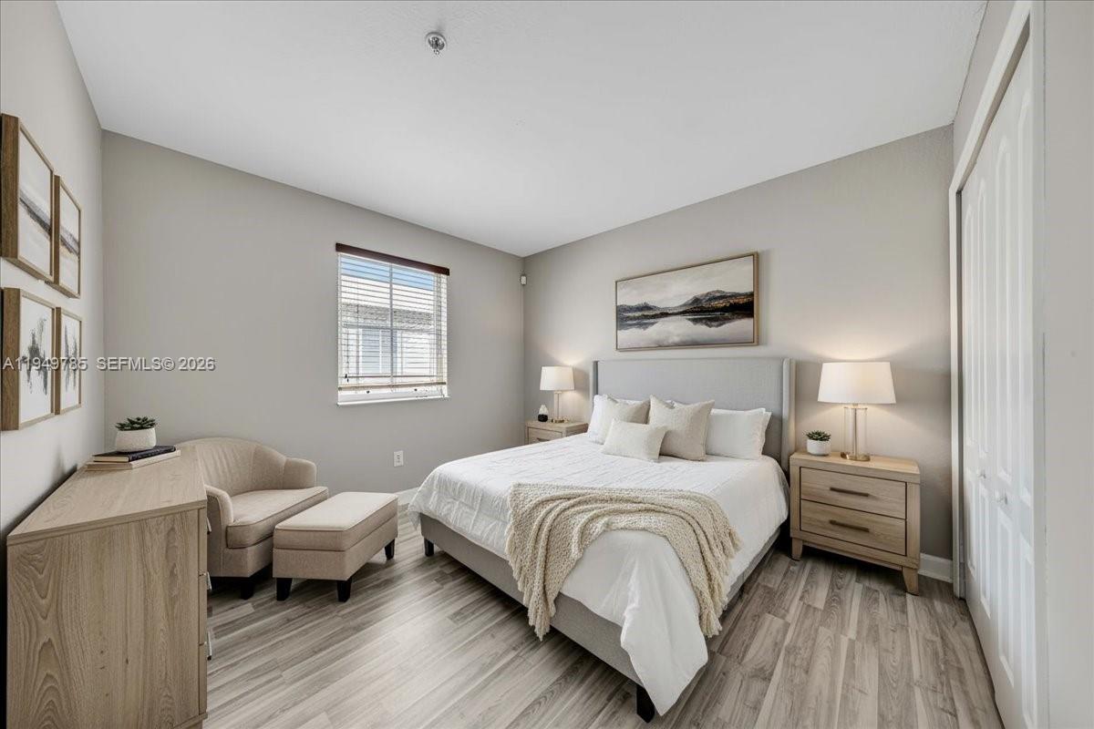 4341 Southwest 160th Avenue, Unit 201 Miramar, FL 33027 - Photo 6 of 53 a bedroom with a bed and wooden floor