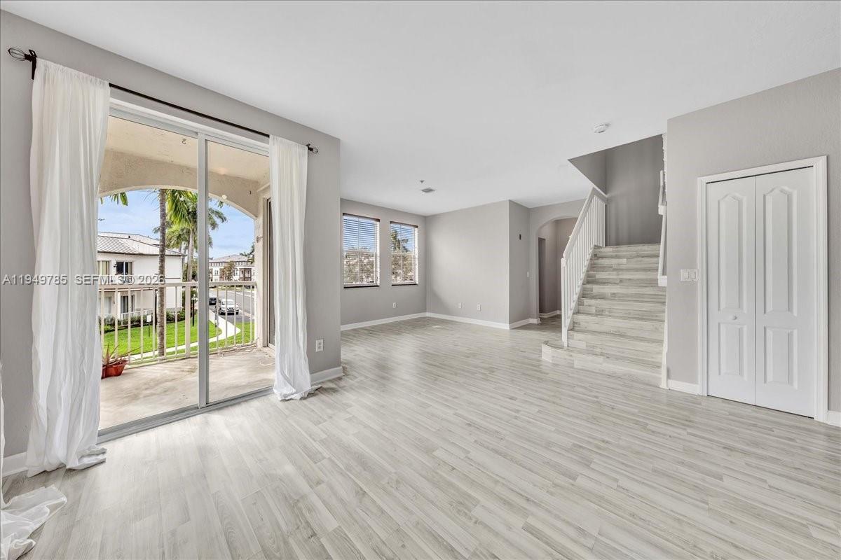 4341 Southwest 160th Avenue, Unit 201 Miramar, FL 33027 - Photo 8 of 53 an empty room with wooden floor and windows