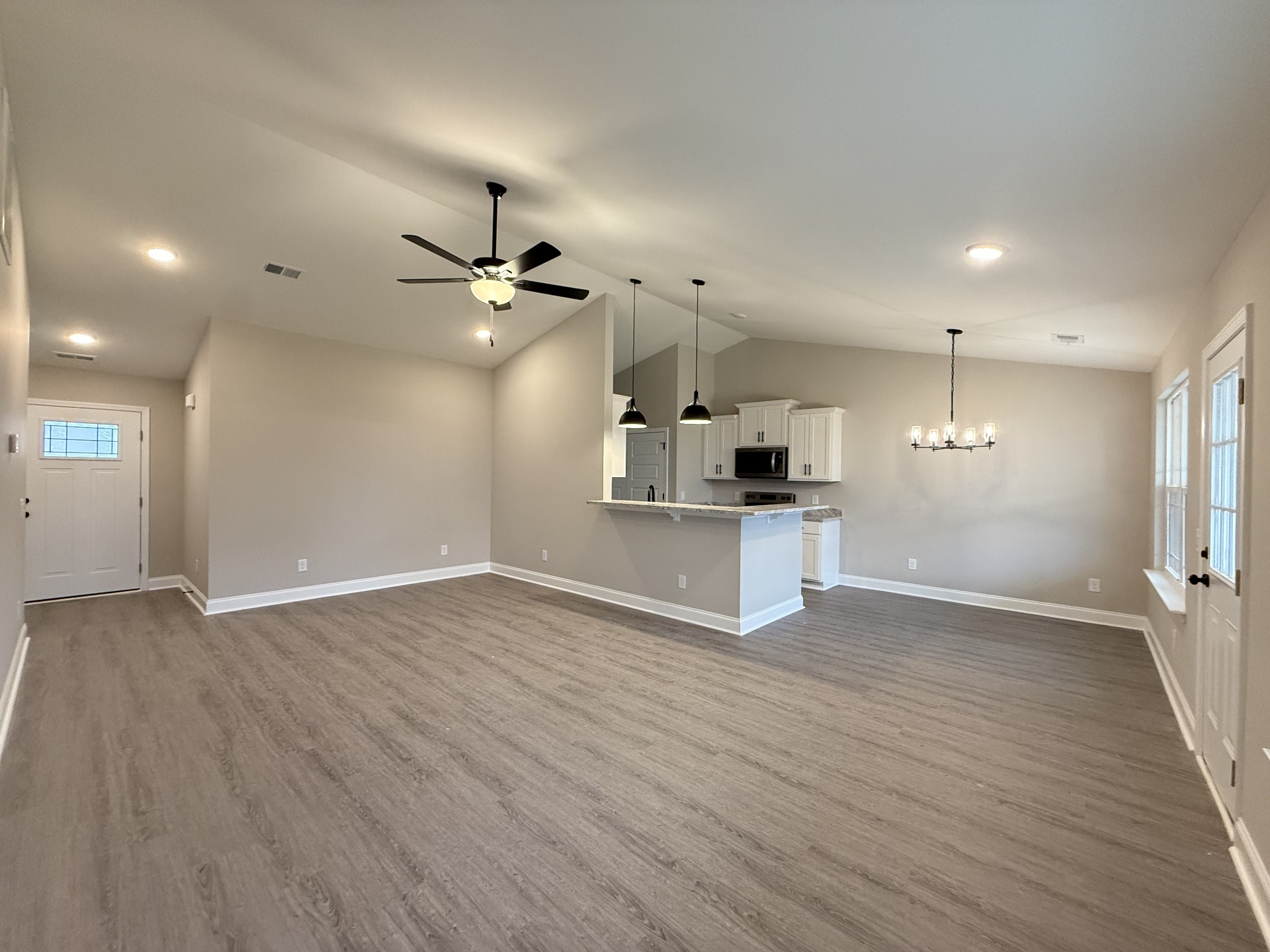 1143 Javier Drive Springfield, TN 37172 - Photo 3 of 7 an empty room with wooden floor and a ceiling fan