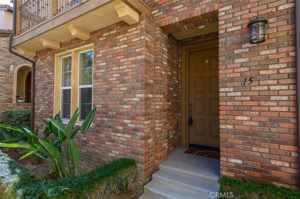 15 Tall Oak Irvine, CA 92603 - Photo 2 of 66 a brick building with a window and potted plants