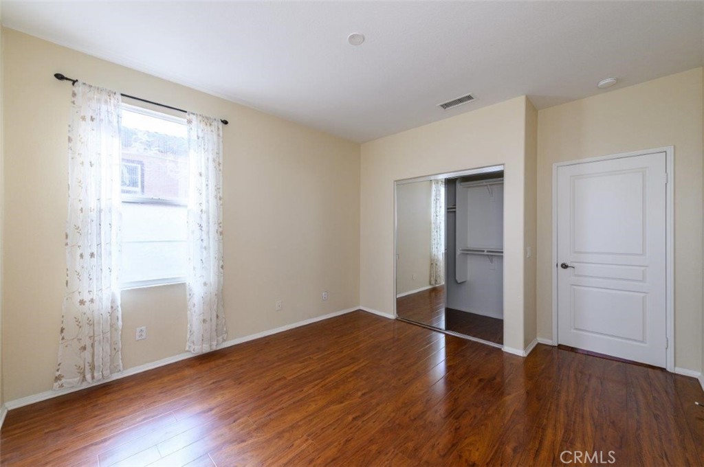 15 Tall Oak Irvine, CA 92603 - Photo 30 of 66 a view of an empty room with closet and wooden floor