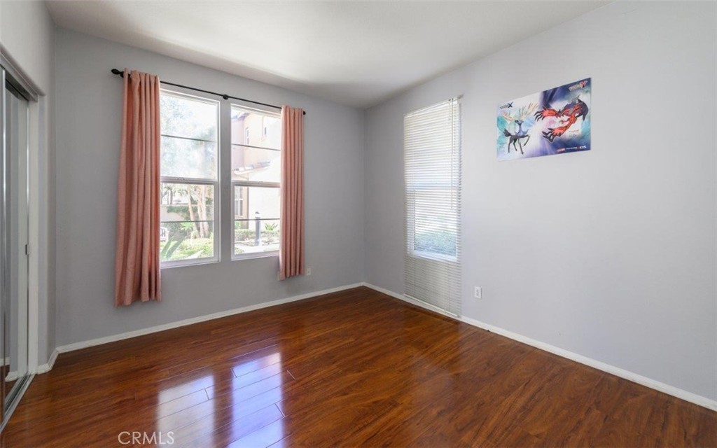 15 Tall Oak Irvine, CA 92603 - Photo 4 of 66 an empty room with wooden floor and windows