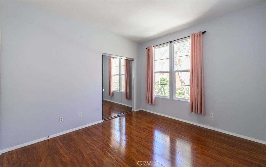 15 Tall Oak Irvine, CA 92603 - Photo 5 of 66 an empty room with wooden floor and windows