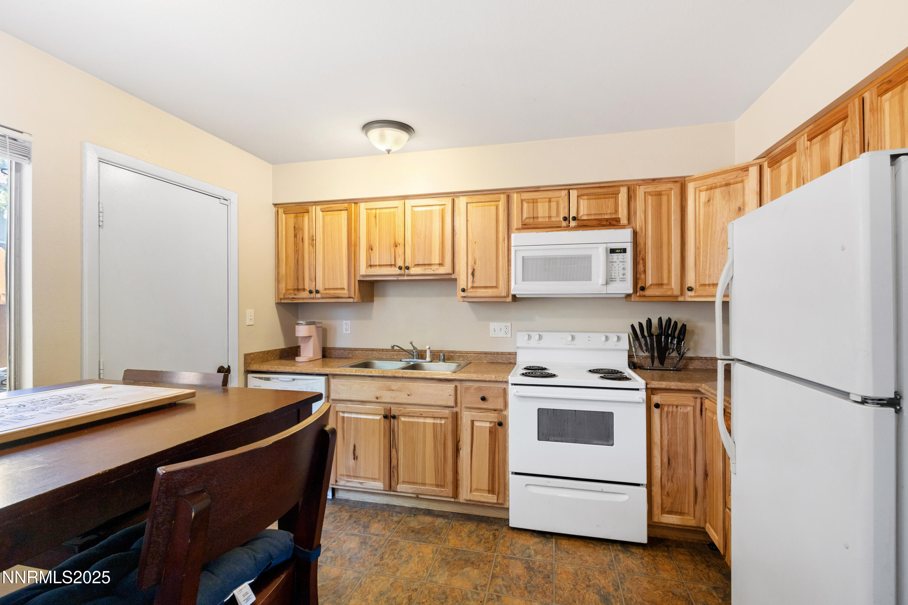 1414 East 9th Street, Unit 4 Reno, NV 89512 - Photo 5 of 16 a kitchen with a refrigerator stove and sink