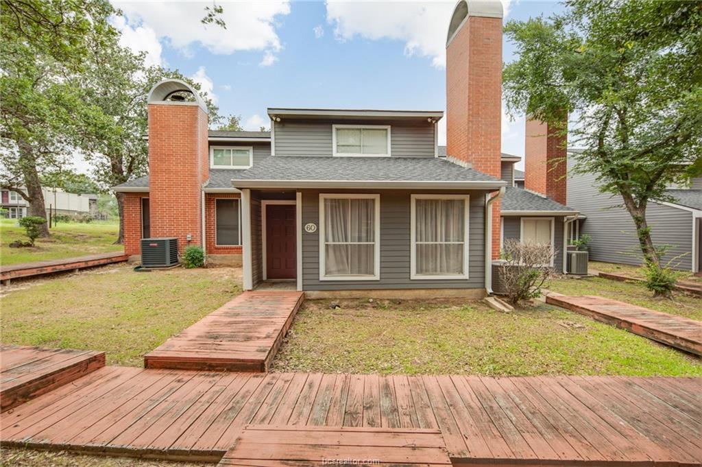 1501 Stallings Drive, Unit 60 College Station, TX 77840 - Photo 1 of 17 a front view of a house with a yard and garage