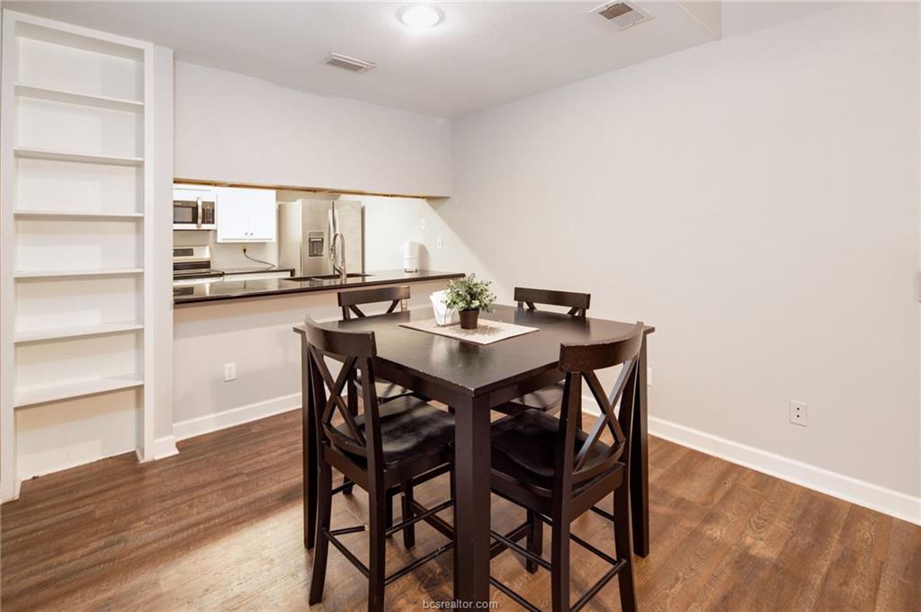 1501 Stallings Drive, Unit 60 College Station, TX 77840 - Photo 5 of 17 a view of a dining room with furniture and wooden floor