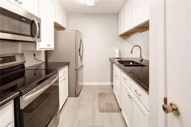 a kitchen with stainless steel appliances granite countertop a stove and a refrigerator