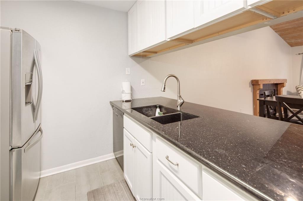 1501 Stallings Drive, Unit 60 College Station, TX 77840 - Photo 8 of 17 a kitchen with stainless steel appliances granite countertop a sink and a refrigerator