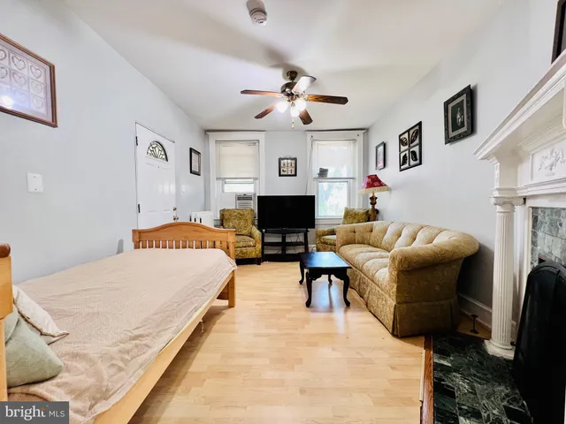 a living room with furniture fireplace and window