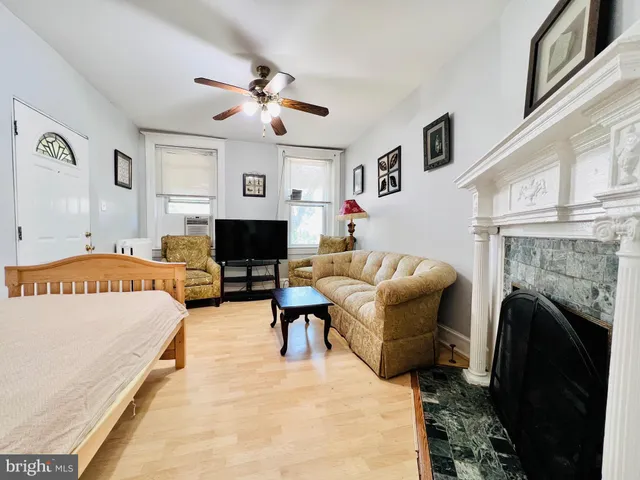 a living room with furniture and a fireplace