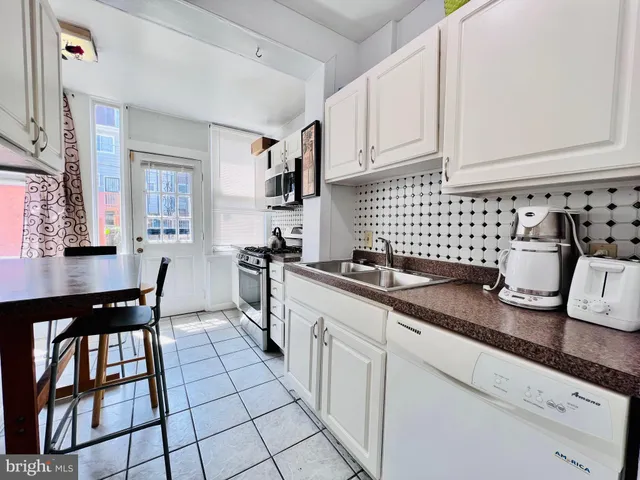 a kitchen with granite countertop a sink and cabinets