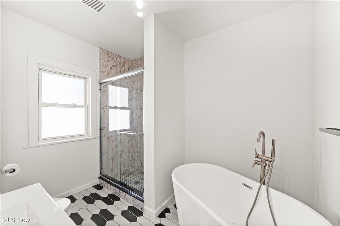 3383 Tullamore Road Cleveland, OH 44118 - Photo 29 of 36 Bathroom with a freestanding tub and a marble finish shower