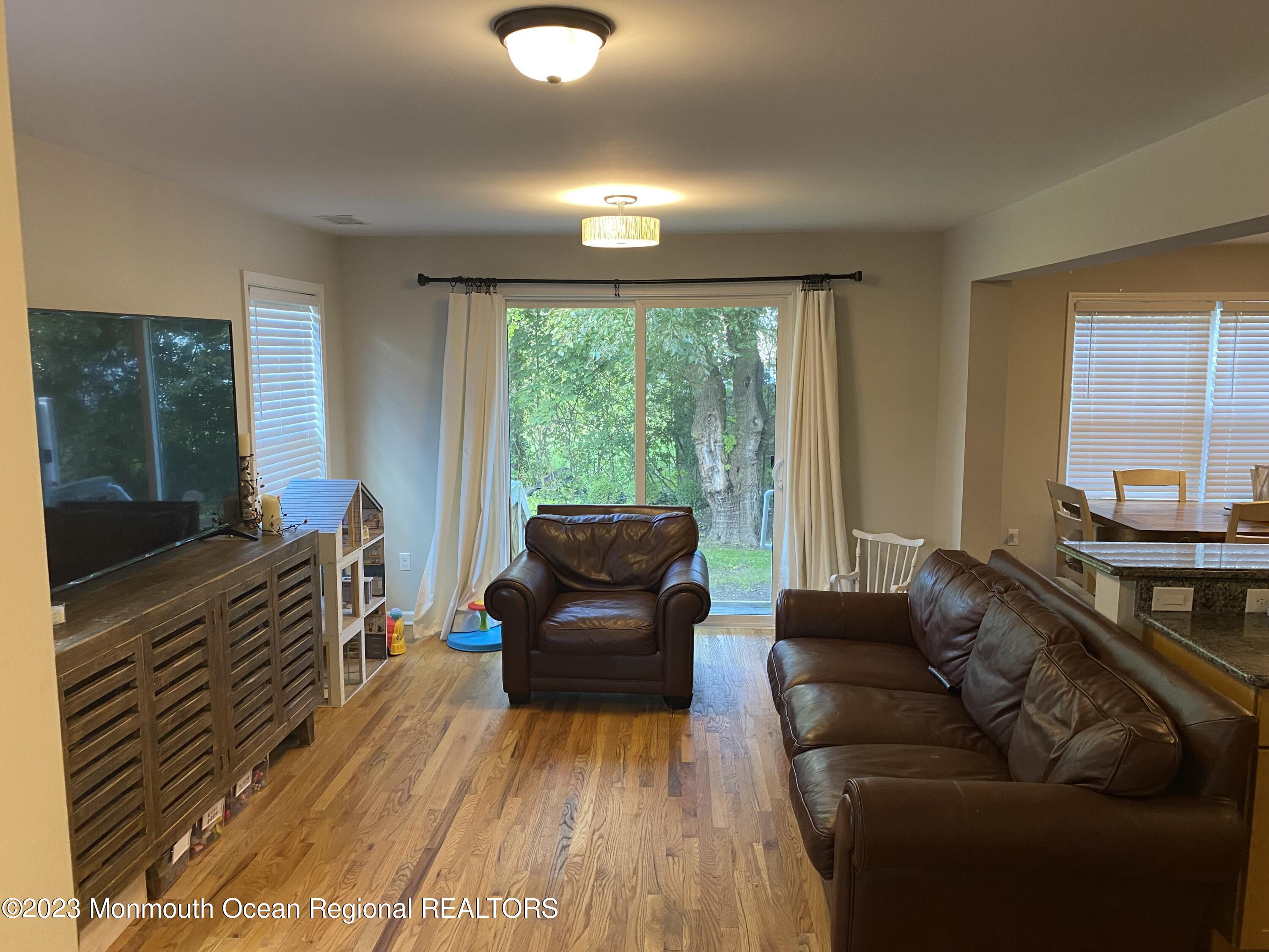 59 Court Street, Unit 2 Long Branch, NJ 07740 - Photo 3 of 8 a living room with furniture and a flat screen tv