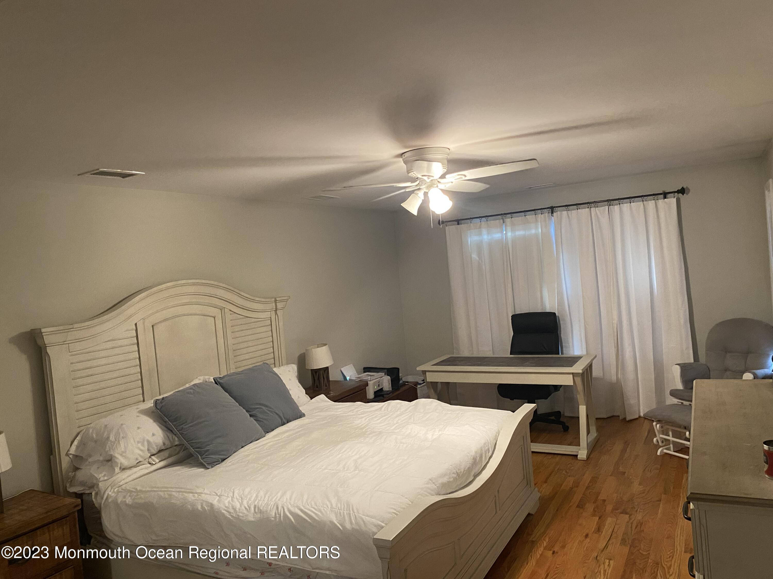 59 Court Street, Unit 2 Long Branch, NJ 07740 - Photo 5 of 8 a bedroom with a bed and wooden floor