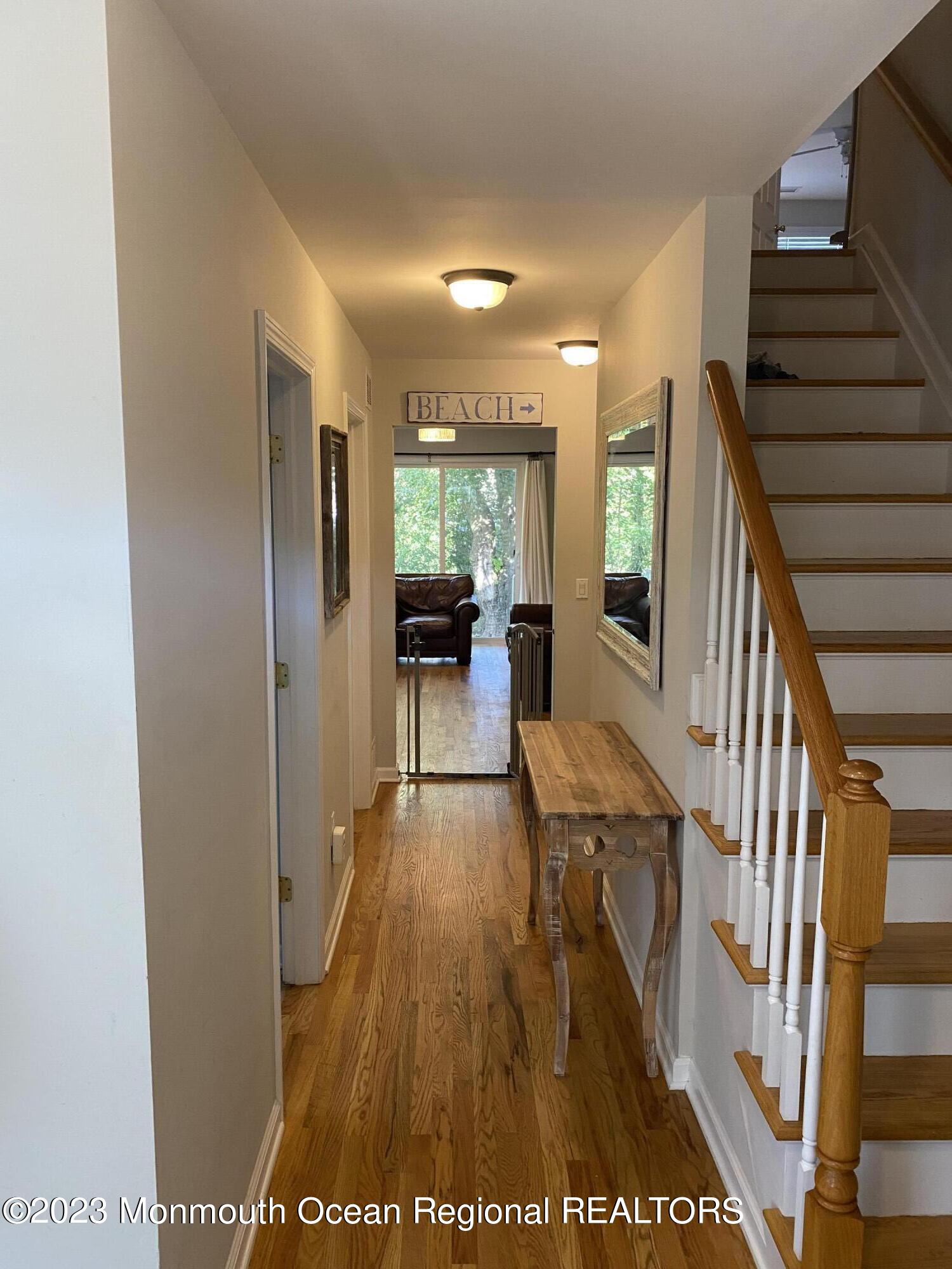 59 Court Street, Unit 2 Long Branch, NJ 07740 - Photo 6 of 8 a view of a hallway with wooden floor and staircase