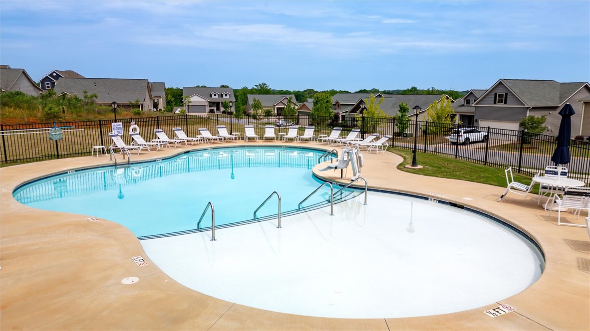 453 Bee Cv Way Pendleton, SC 29670 - Photo 24 of 25 A refreshing community pool with ample lounge seating, perfect for summer relaxation.