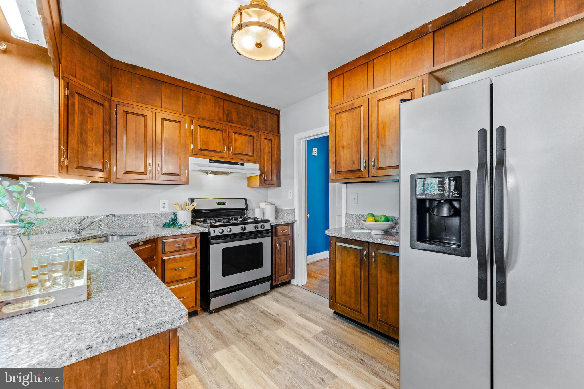 1840 Deveron Road Towson, MD 21286 - Photo 17 of 43 a kitchen with stainless steel appliances granite countertop a refrigerator a stove top oven a sink and dishwasher