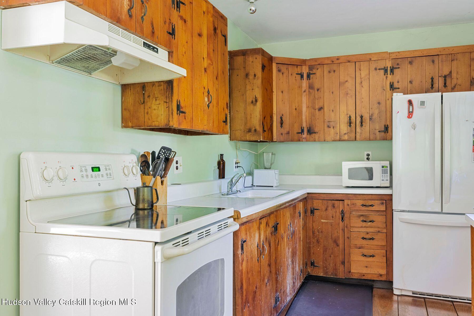 392-396 Cottekill Road Kingston, NY 12401 - Photo 20 of 34 a kitchen with a sink a stove and refrigerator