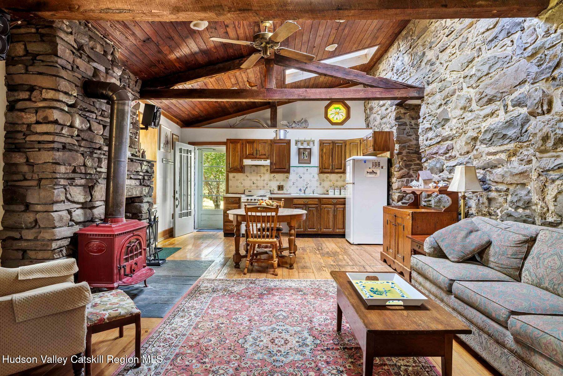 392-396 Cottekill Road Kingston, NY 12401 - Photo 5 of 34 a living room with furniture a fireplace and a table