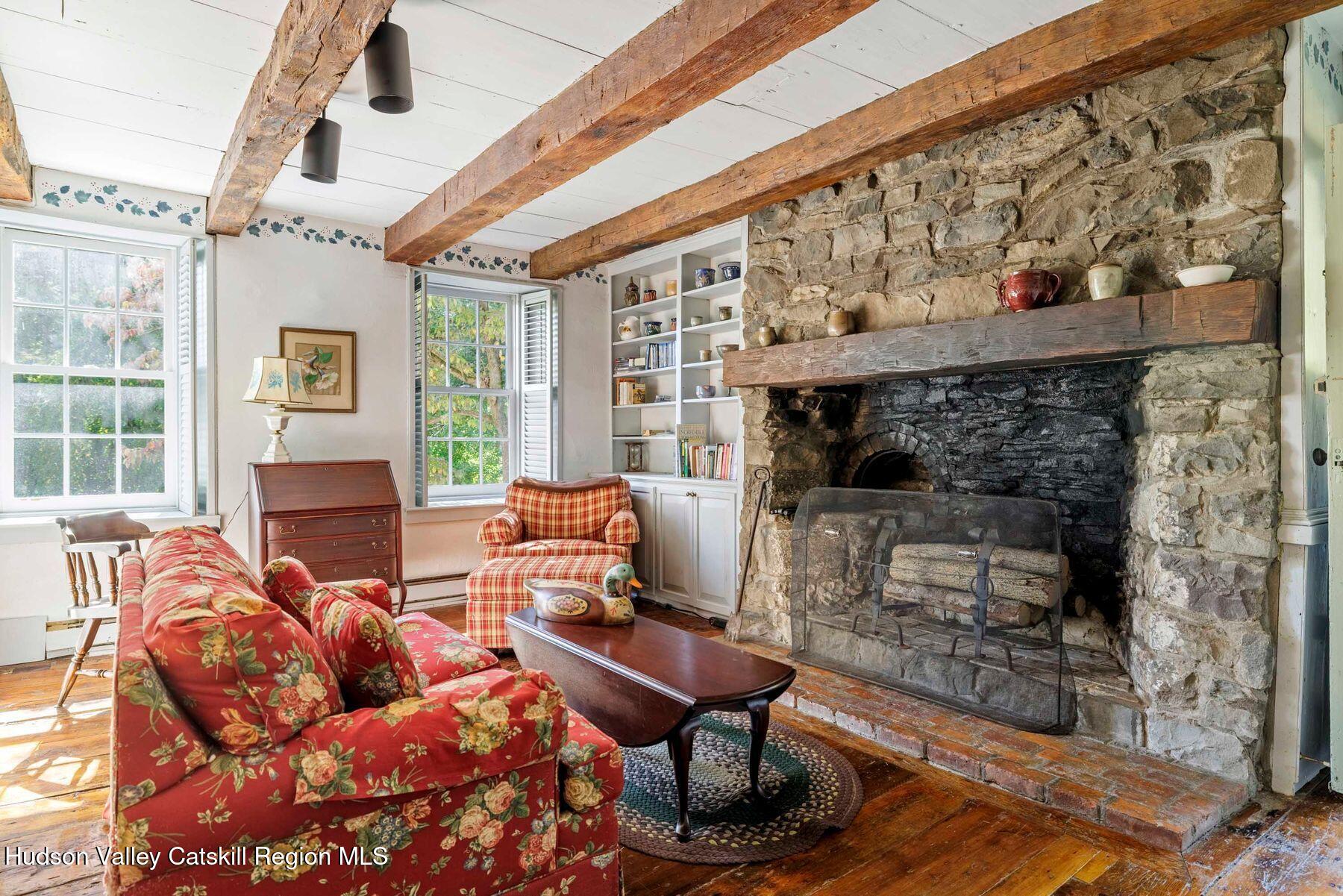 392-396 Cottekill Road Kingston, NY 12401 - Photo 6 of 34 a living room with furniture a fireplace and a table