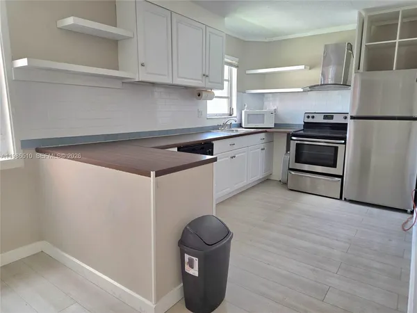 a kitchen with a sink stainless steel appliances and cabinets