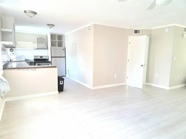 a kitchen with stainless steel appliances granite countertop a refrigerator a stove and a sink