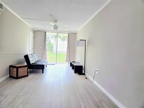 a living room with furniture and large windows