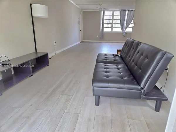 a living room with furniture and a window