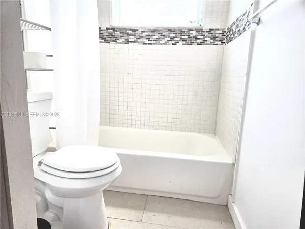 a bathroom with a bathtub and a toilet
