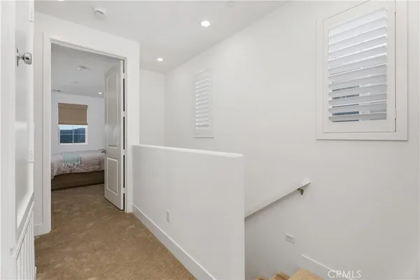 a view of a hallway with a livingroom and a bathroom