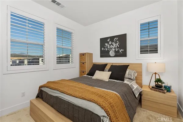 a bedroom with bed and window