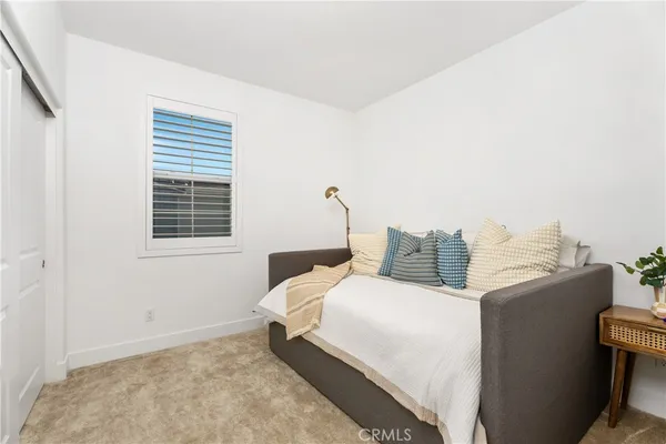 a bedroom with a bed and a window