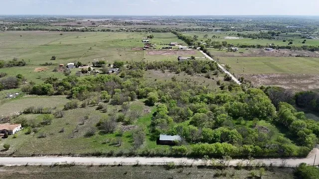 an aerial view of a houses with a yard