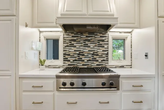 a stove top oven sitting inside of a kitchen