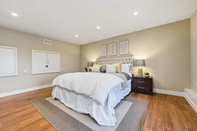 a bed room with a bed and a night stand