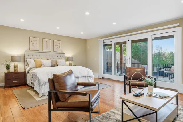 a bedroom with furniture and a large window