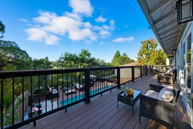 a view of balcony with wooden floor and outdoor seating