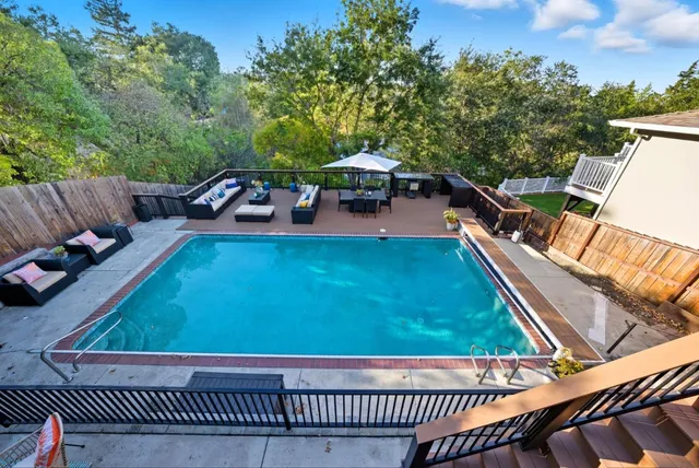 a view of a chairs and table on the roof deck