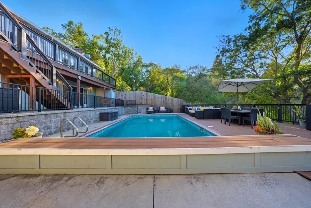 a view of swimming pool with chairs