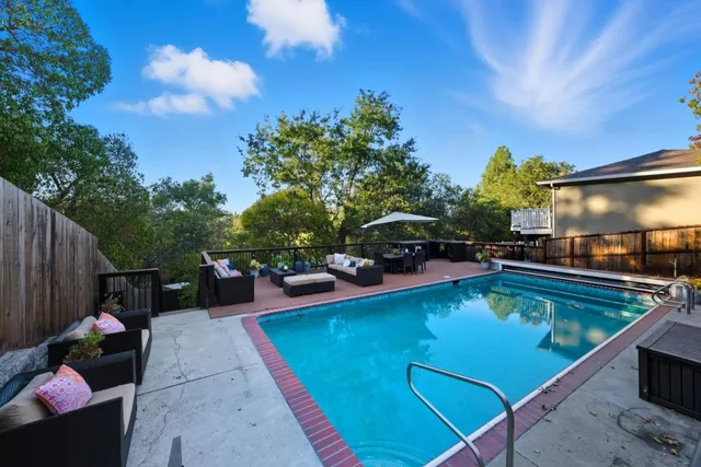a view of swimming pool with outdoor seating