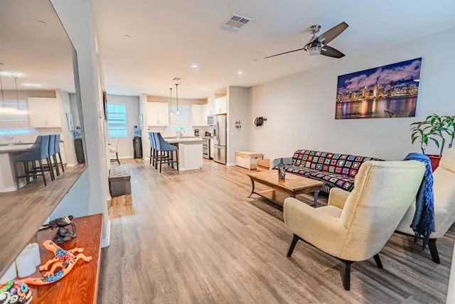 a living room with furniture and a wooden floor