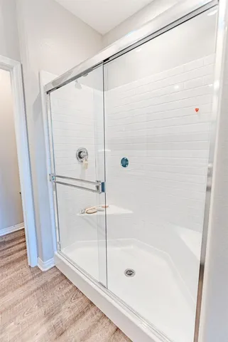 a bathroom with a glass shower door