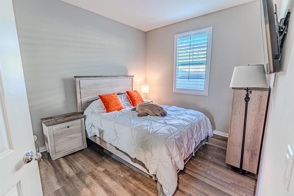 504 Hummingbird Lane Imperial Beach, CA 91932 - Photo 18 of 25 a bedroom with a bed and a flat tv screen on a dresser