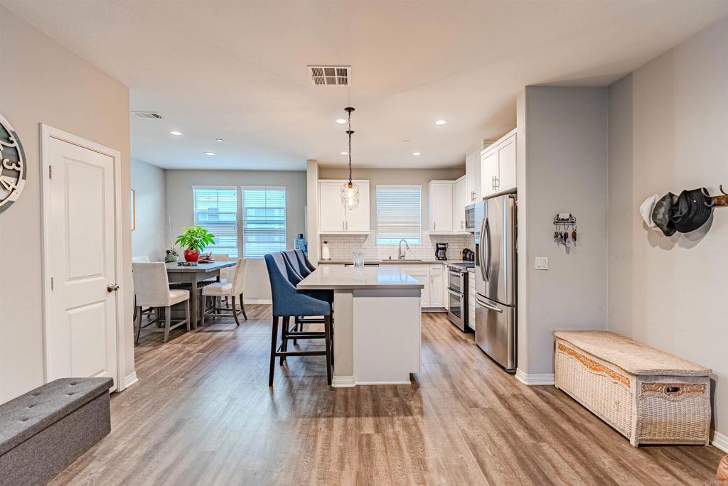 504 Hummingbird Lane Imperial Beach, CA 91932 - Photo 6 of 25 a kitchen with a table chairs refrigerator and microwave