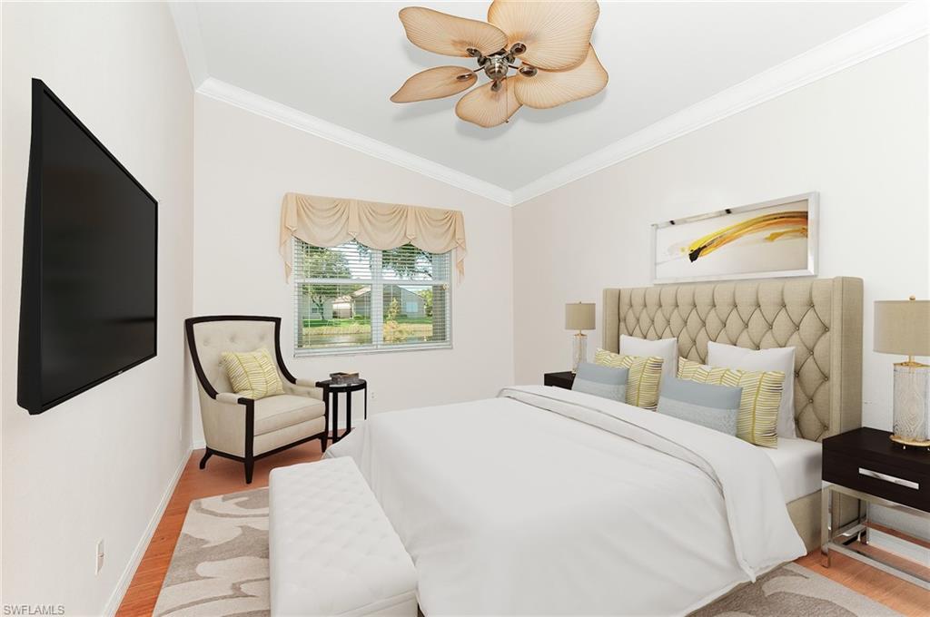 9381 Springview Loop Estero, FL 33928 - Photo 12 of 35 a bedroom with a bed and a chandelier